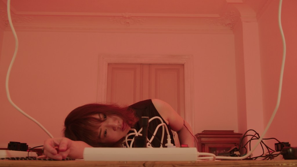 Emil Vijgen: Horizontal Living (2022-2023) for performer with tape, extension cords, sockets, phone chargers, text and video